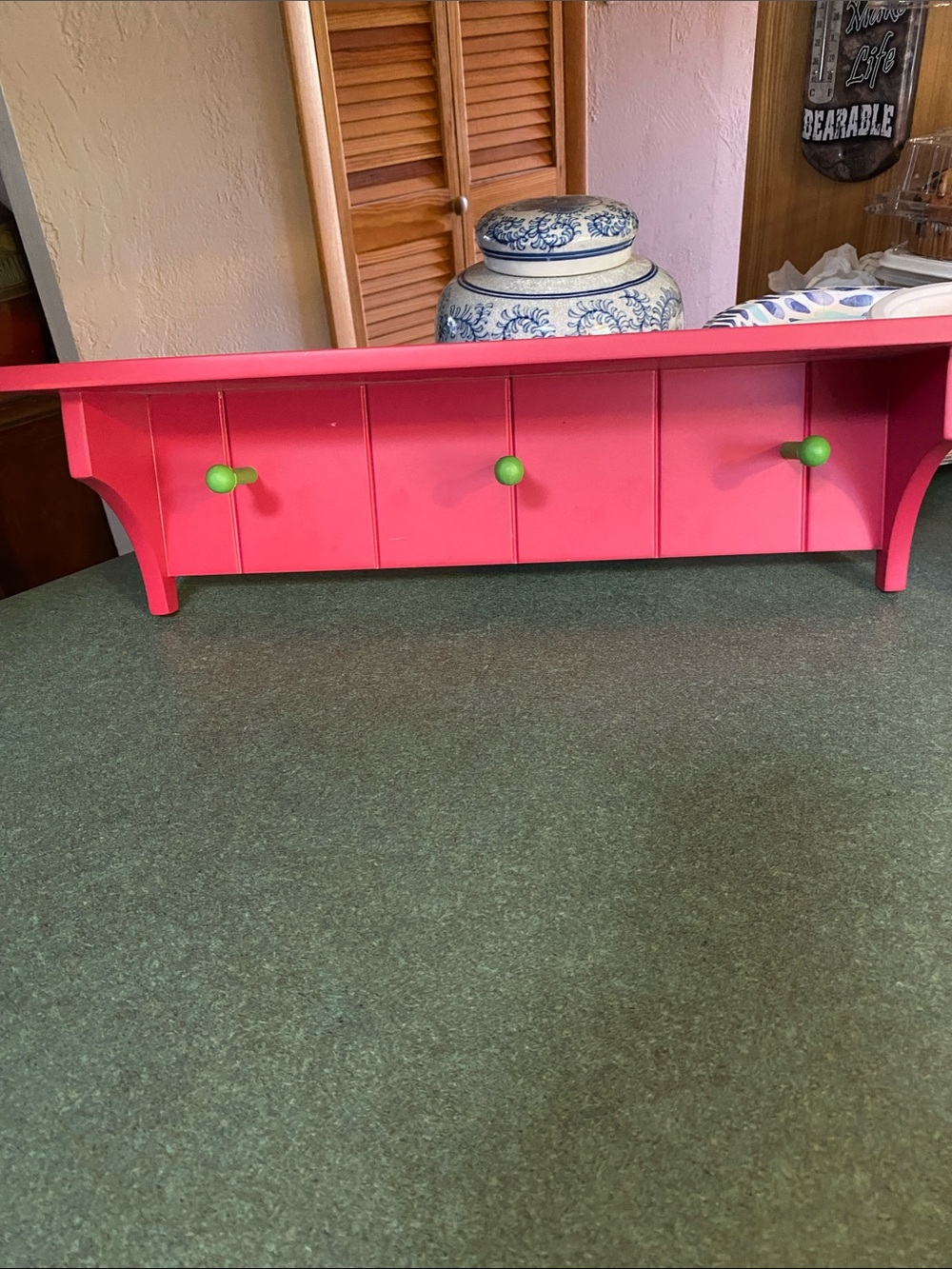 Bright Pink Wall Shelf with Green Pegs
